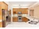 Spacious kitchen with stainless steel appliances, light wood cabinets and a breakfast bar at 19261 Quarterly Pkwy, Orlando, FL 32833