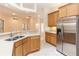 Modern kitchen featuring a stainless steel refrigerator, stone countertops, and open access at 19261 Quarterly Pkwy, Orlando, FL 32833