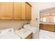 Efficient laundry room featuring overhead cabinetry, a utility sink, and modern washer and dryer at 19261 Quarterly Pkwy, Orlando, FL 32833
