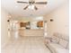 Open living space featuring a view of the kitchen, tile flooring, and neutral color palette at 19261 Quarterly Pkwy, Orlando, FL 32833