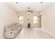 Spacious living room with tile flooring, ceiling fan, and natural light from large windows at 19261 Quarterly Pkwy, Orlando, FL 32833