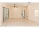 Bright living room with neutral colors, tile flooring, and sliding glass doors to the outside at 19261 Quarterly Pkwy, Orlando, FL 32833