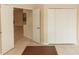 Open living room space with neutral tile and doorways leading to other rooms at 19261 Quarterly Pkwy, Orlando, FL 32833