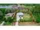 Aerial view of a single-story home on large lot, surrounded by trees and a lake nearby at 19261 Quarterly Pkwy, Orlando, FL 32833