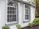 Exterior showcasing arched windows with white frames, adding architectural detail to the home at 19261 Quarterly Pkwy, Orlando, FL 32833