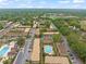 Expansive aerial view of a community with mature trees and a pool at 200 St Andrews Blvd # 512, Winter Park, FL 32792