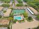 Aerial view of community featuring a pool, tennis court, and well-maintained landscaping at 200 St Andrews Blvd # 512, Winter Park, FL 32792