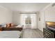 Bedroom featuring two twin beds, hardwood floors, and a large window at 200 St Andrews Blvd # 512, Winter Park, FL 32792