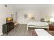 Bedroom featuring two twin beds, hardwood floors, and a TV console at 200 St Andrews Blvd # 512, Winter Park, FL 32792