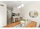 Cozy dining area with stylish light fixture, table decor, and adjacent kitchen at 200 St Andrews Blvd # 512, Winter Park, FL 32792