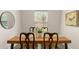 Cozy dining space featuring wood table, chairs, and natural light streaming through a window at 200 St Andrews Blvd # 512, Winter Park, FL 32792