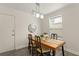 Bright dining room with modern lighting, seating for four, and sleek wood-look floors at 200 St Andrews Blvd # 512, Winter Park, FL 32792