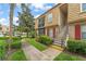 Charming condo building featuring red shutters and well-maintained landscaping at 200 St Andrews Blvd # 512, Winter Park, FL 32792