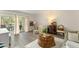 Bright living room with wood floors, plush seating, and a view of the outdoor patio at 200 St Andrews Blvd # 512, Winter Park, FL 32792