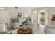 Open-concept living area featuring wood floors, neutral tones, and access to the outdoor patio at 200 St Andrews Blvd # 512, Winter Park, FL 32792
