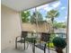 Enjoy outdoor seating on this screened patio with a lovely view of trees and parking at 200 St Andrews Blvd # 512, Winter Park, FL 32792