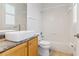 A bright bathroom with a modern sink, wood vanity, and a shower/tub combo at 2328 Warren Woods Dr, Orlando, FL 32835