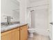 A full bathroom with a tub and shower combination, with wood cabinet and granite countertop at 2328 Warren Woods Dr, Orlando, FL 32835