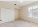 Cozy bedroom with neutral carpet, double closet doors, and a window with shutters at 2328 Warren Woods Dr, Orlando, FL 32835