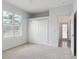 A bedroom featuring neutral carpet, closet, and window with shutters at 2328 Warren Woods Dr, Orlando, FL 32835