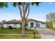 Charming single-story home featuring manicured lawn, brick paved driveway, and neutral color palette at 2328 Warren Woods Dr, Orlando, FL 32835