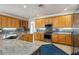 Gourmet kitchen featuring stainless steel appliances, granite countertops, and custom wood cabinetry at 2328 Warren Woods Dr, Orlando, FL 32835