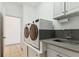This laundry room features a modern washer and dryer set, a sink, and white cabinetry at 2328 Warren Woods Dr, Orlando, FL 32835