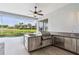 Outdoor kitchen features stainless steel appliances, custom cabinetry, and a screened patio overlooking the pool and backyard at 2328 Warren Woods Dr, Orlando, FL 32835