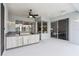 A covered outdoor kitchen with stainless steel appliances, a built-in grill, and a view of the backyard at 2328 Warren Woods Dr, Orlando, FL 32835