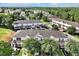 Aerial view of townhomes surrounded by lush greenery and a blue sky at 2355 Silver Palm Dr, Kissimmee, FL 34747