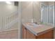 Bathroom featuring a staircase view with a classic vanity, sink and neutral tile flooring at 2355 Silver Palm Dr, Kissimmee, FL 34747