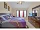 Comfortable bedroom featuring a ceiling fan, three windows, a dresser and a TV at 2355 Silver Palm Dr, Kissimmee, FL 34747
