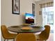 Dining area with round table, yellow chairs, and modern decor at 2355 Silver Palm Dr, Kissimmee, FL 34747