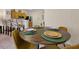 Dining area with a round table, set plates, and a bar in the background at 2355 Silver Palm Dr, Kissimmee, FL 34747
