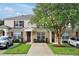Well maintained townhome showcasing front lawn and red shutters at 2355 Silver Palm Dr, Kissimmee, FL 34747