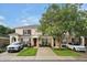 Attractive townhome featuring neat lawn, red shutters and a flowering shade tree at 2355 Silver Palm Dr, Kissimmee, FL 34747