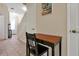 Hallway with a black writing desk and chair, leading to the front door at 2355 Silver Palm Dr, Kissimmee, FL 34747