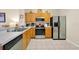 Efficient kitchen featuring tile flooring, stainless steel refrigerator, and breakfast bar at 2355 Silver Palm Dr, Kissimmee, FL 34747