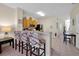 Open kitchen with bar seating, appliances and adjacent dining area at 2355 Silver Palm Dr, Kissimmee, FL 34747