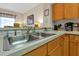 Bright kitchen with stainless steel sink, wood cabinets and ample counter space at 2355 Silver Palm Dr, Kissimmee, FL 34747