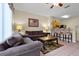 Cozy living room open to kitchen with tile floors, ceiling fan, and breakfast bar at 2355 Silver Palm Dr, Kissimmee, FL 34747