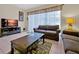Comfortable living room featuring neutral tones, tile flooring, and a sliding glass door at 2355 Silver Palm Dr, Kissimmee, FL 34747