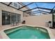 Backyard pool with screen enclosure, brick pavers and patio seating at 2355 Silver Palm Dr, Kissimmee, FL 34747
