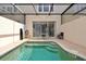 Private pool with screened-in enclosure, brick pavers and access to sliding doors at 2355 Silver Palm Dr, Kissimmee, FL 34747