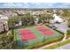 Aerial view of the community tennis courts, pool, and clubhouse with ample parking at 2355 Silver Palm Dr, Kissimmee, FL 34747