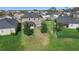 Expansive backyard showing green space, mature trees, and neighboring houses, ideal for outdoor activities at 2383 Regency Park Dr, Deland, FL 32724