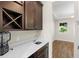 Butler's pantry area featuring modern countertops, custom cabinets, and built-in wine storage at 2383 Regency Park Dr, Deland, FL 32724