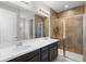 Modern bathroom features a double sink vanity and a glass-enclosed shower with brown tile surround at 2383 Regency Park Dr, Deland, FL 32724