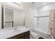 Well-lit bathroom with a white vanity, tub-shower combo, and decorative shower curtain at 2383 Regency Park Dr, Deland, FL 32724