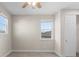 Bright bedroom with neutral walls, carpet flooring, and windows offering natural light and neighborhood views at 2383 Regency Park Dr, Deland, FL 32724